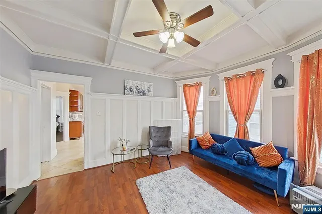 a living room with furniture fireplace and a large window
