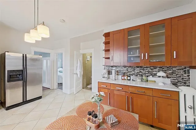 a spacious bathroom with a granite countertop sink a mirror and a shower