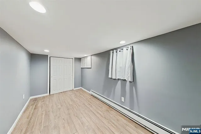 a view of a room with wooden floor