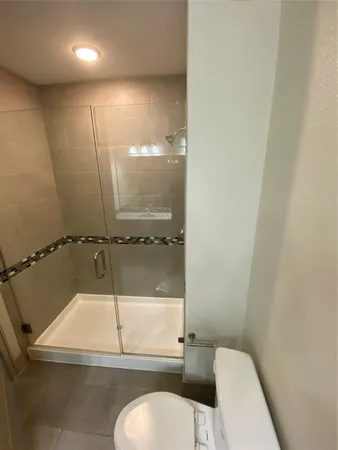 a bathroom with a toilet and a shower