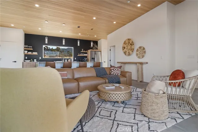 a bedroom with a bed and paintings on wall