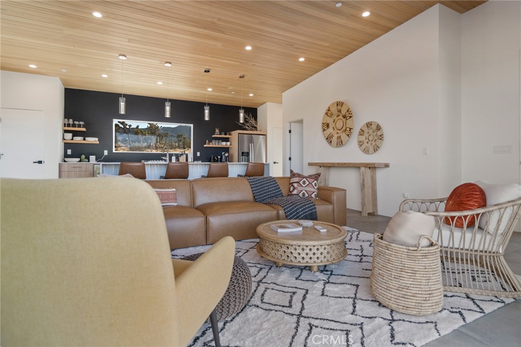 6737 Saddleback Road Joshua Tree, CA 92252 - Photo 16 of 65 a living room with furniture and a table