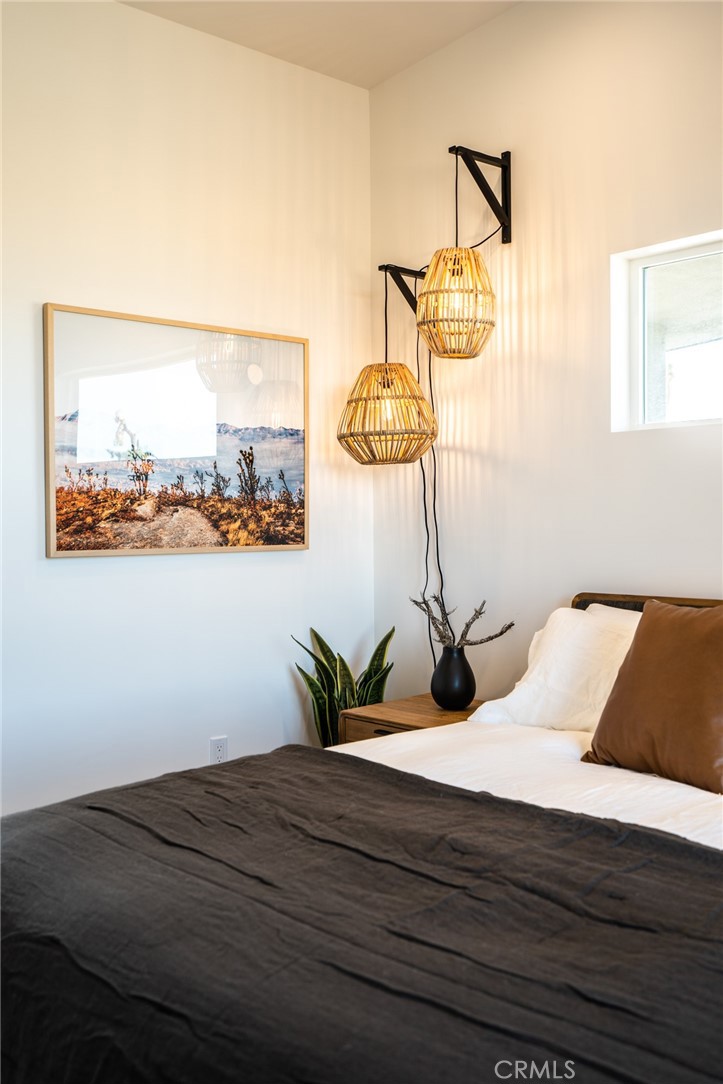 6737 Saddleback Road Joshua Tree, CA 92252 - Photo 22 of 65 a bed sitting in a bedroom next to a window