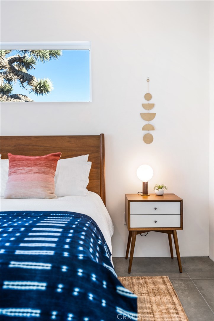 6737 Saddleback Road Joshua Tree, CA 92252 - Photo 25 of 65 a bedroom with a bed and a table