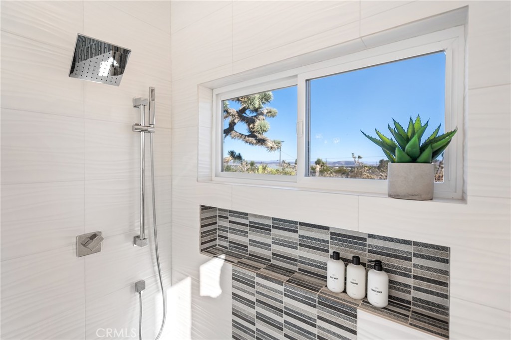 6737 Saddleback Road Joshua Tree, CA 92252 - Photo 30 of 65 a bathroom with a sink a mirror and a potted plant
