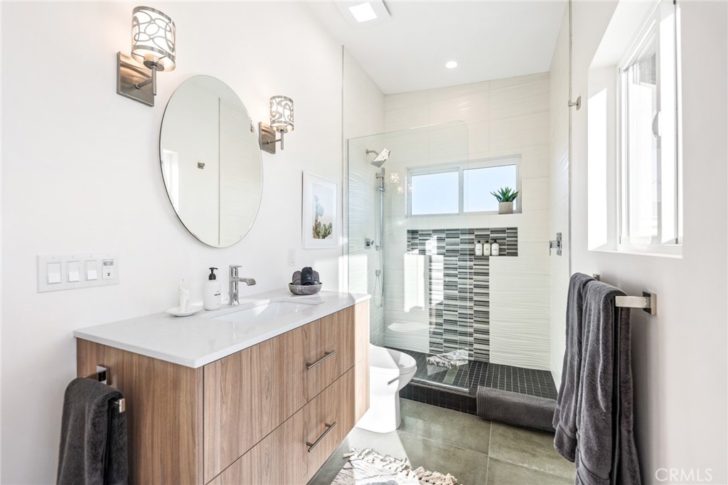 6737 Saddleback Road Joshua Tree, CA 92252 - Photo 32 of 65 a bathroom with a sink a mirror and a shower