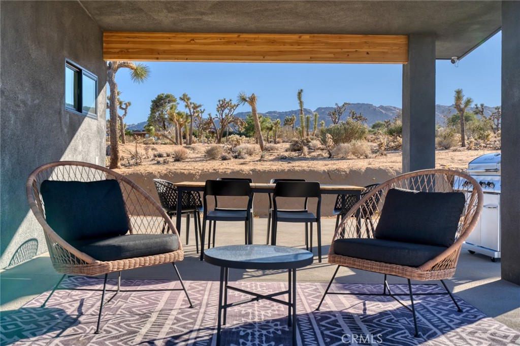6737 Saddleback Road Joshua Tree, CA 92252 - Photo 36 of 65 a view of a chairs and table in the patio