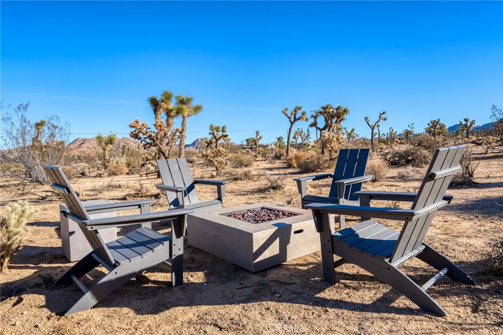 6737 Saddleback Road Joshua Tree, CA 92252 - Photo 38 of 65 a view of a terrace with furniture and a table