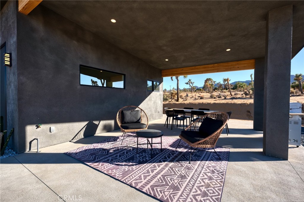 6737 Saddleback Road Joshua Tree, CA 92252 - Photo 47 of 65 a living room with furniture and a large window