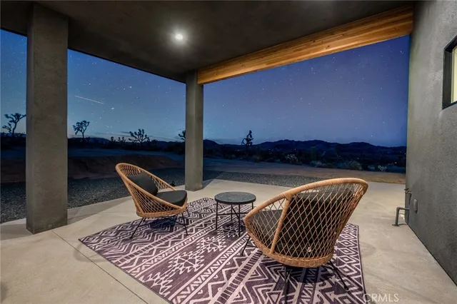 a view of a room with lots of windows and a table