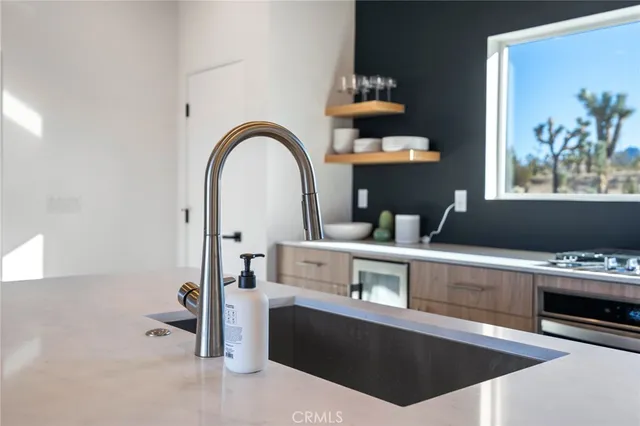 a living room with furniture a floor to ceiling window and potted plant