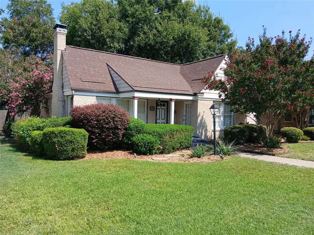 a aerial view of a house with a yard and potted plants