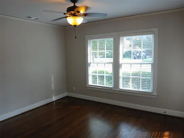 a view of a room with wooden floor and a window