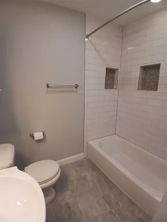 a bathroom with a toilet and bathtub