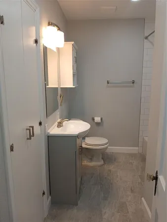 a bathroom with a sink a toilet and mirror