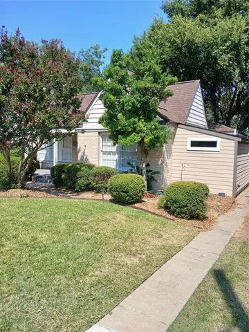 a backyard of a house with plants and trees