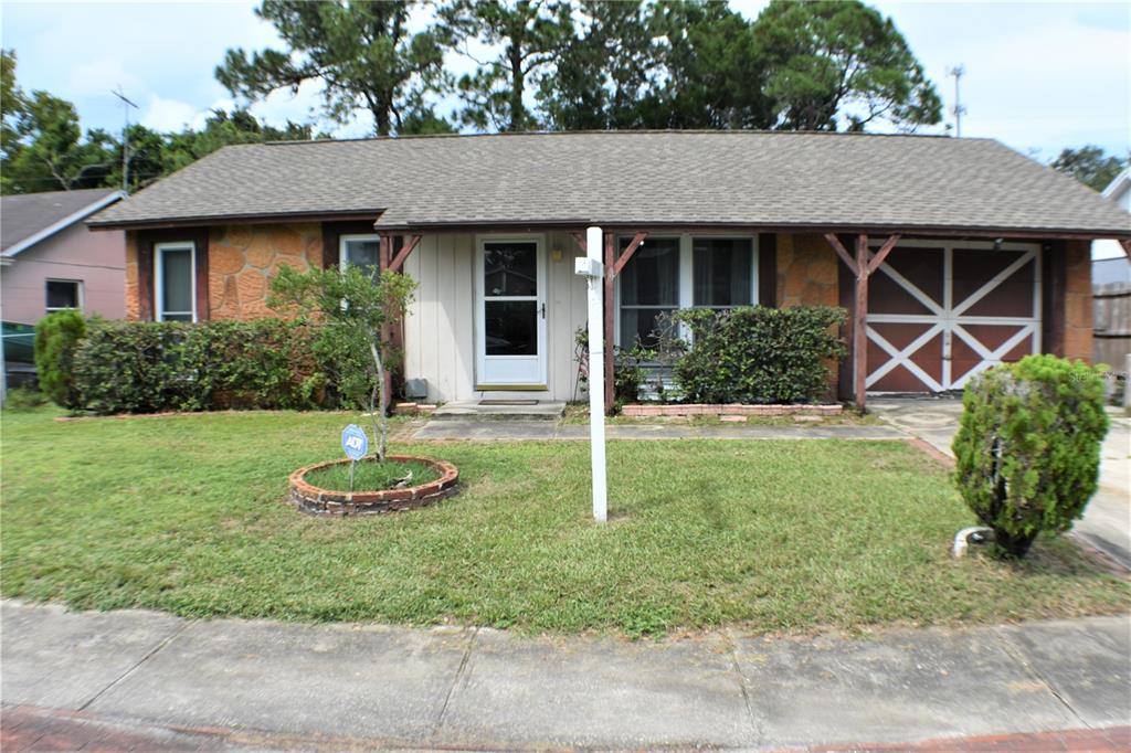 7986 Aden Loop New Port Richey, FL 34655 - Photo 1 of 1 a front view of a house with garden