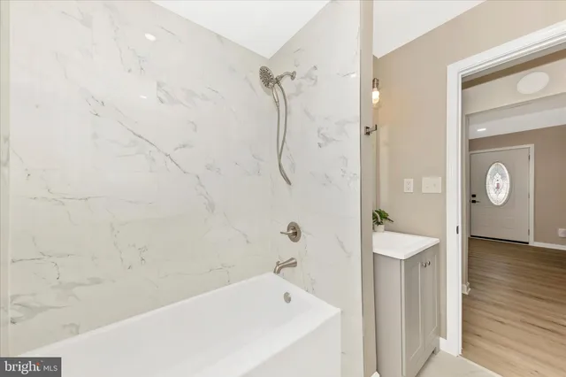 a bathroom with a bathtub and a shower