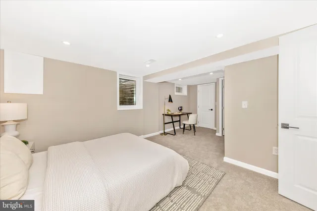 a spacious bedroom with a bed and a chair