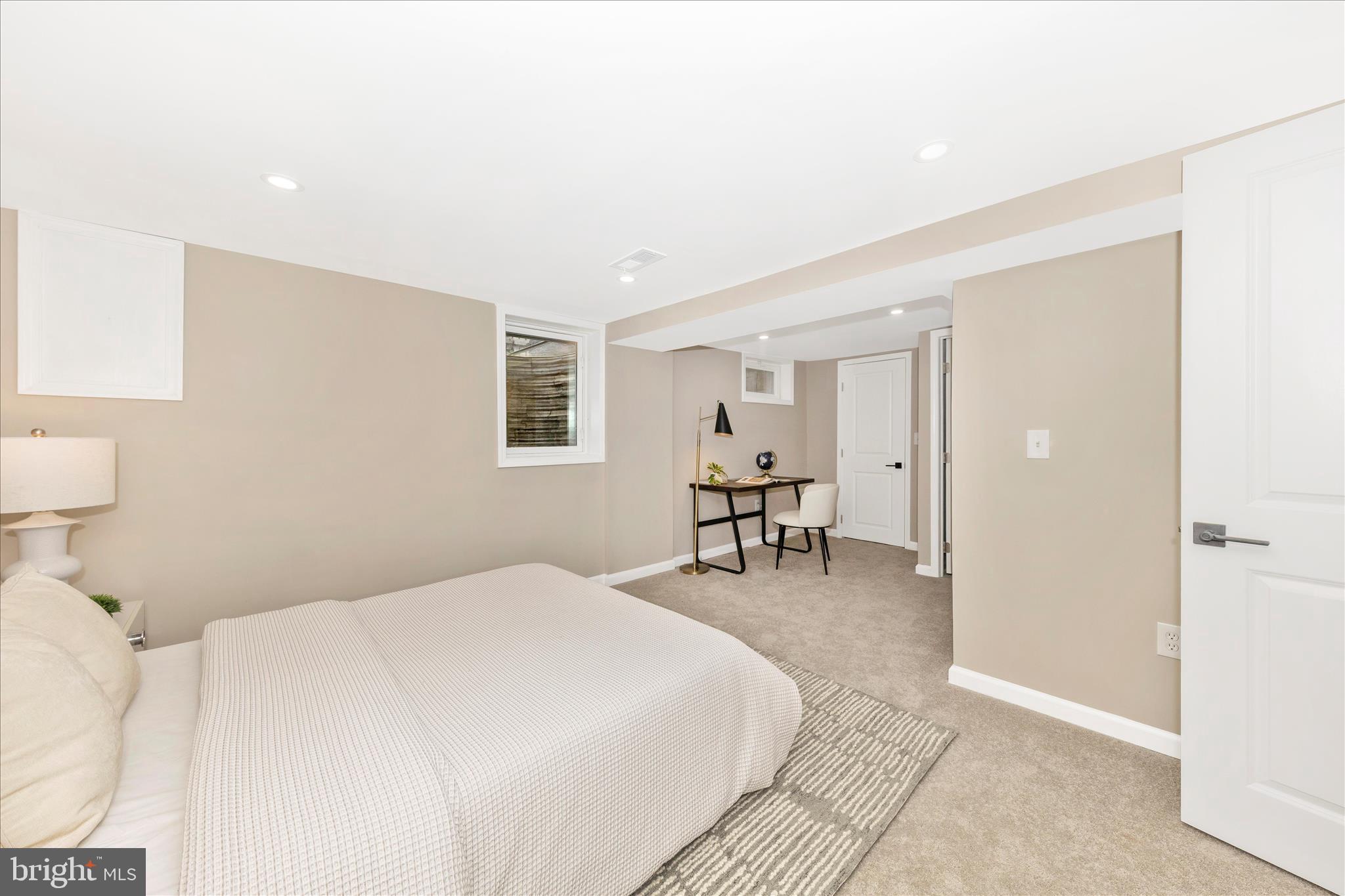 2506 Lindell Street Silver Spring, MD 20902 - Photo 16 of 47 a spacious bedroom with a bed and a chair