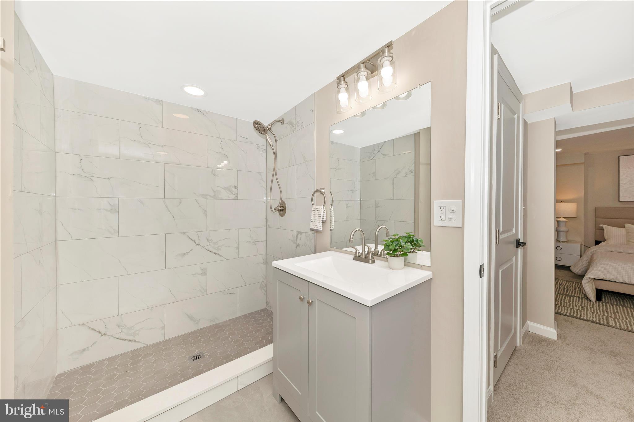 2506 Lindell Street Silver Spring, MD 20902 - Photo 26 of 47 a bathroom with a sink a mirror and a shower