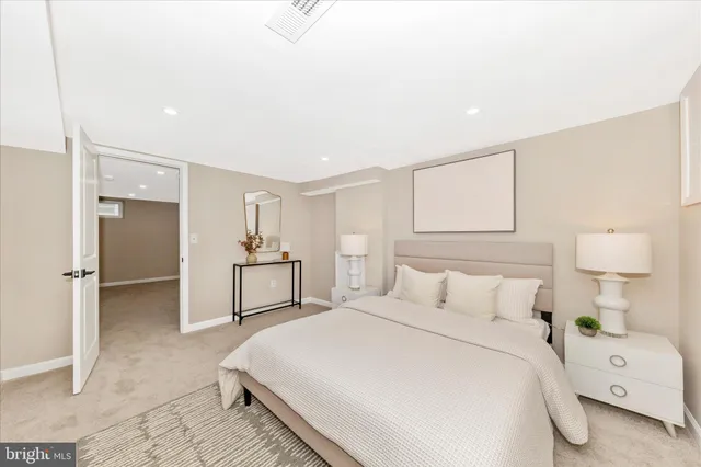 a bedroom with a bed and a refrigerator