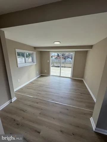 wooden floor in an empty room with window