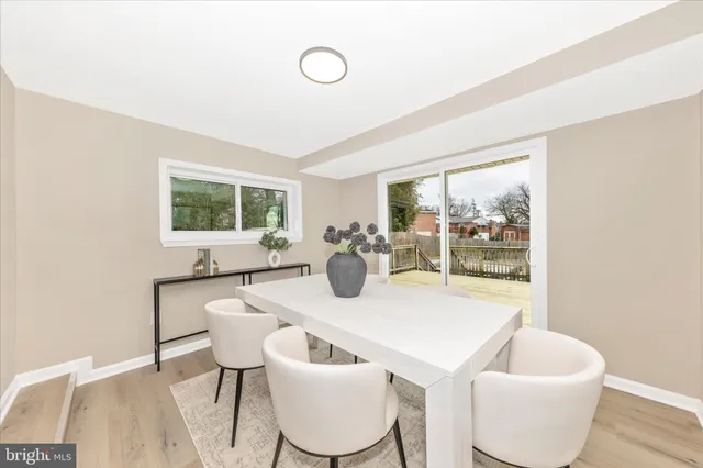 a dining room with furniture and a window