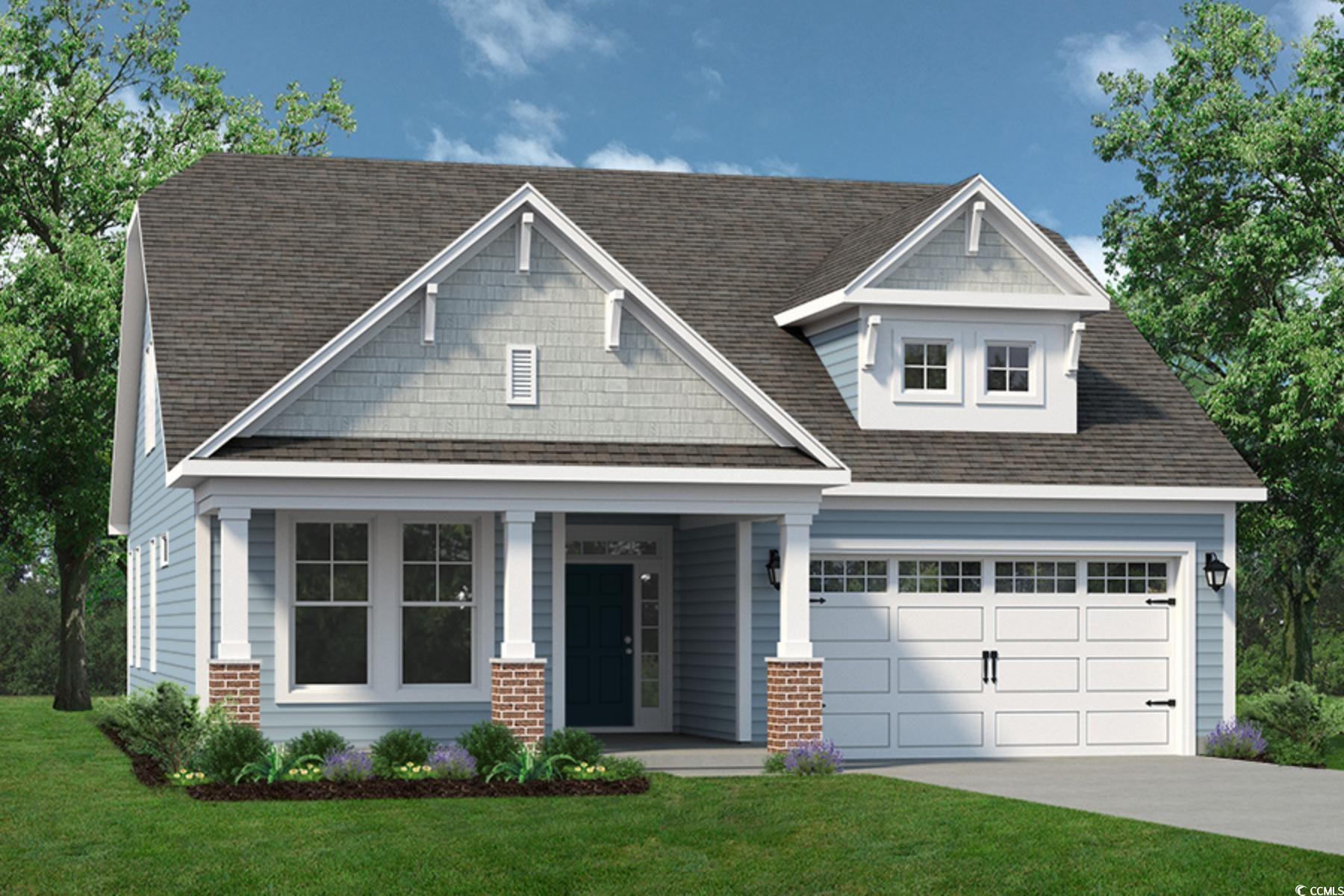 Craftsman-style home featuring covered porch, a front lawn, a garage, and driveway