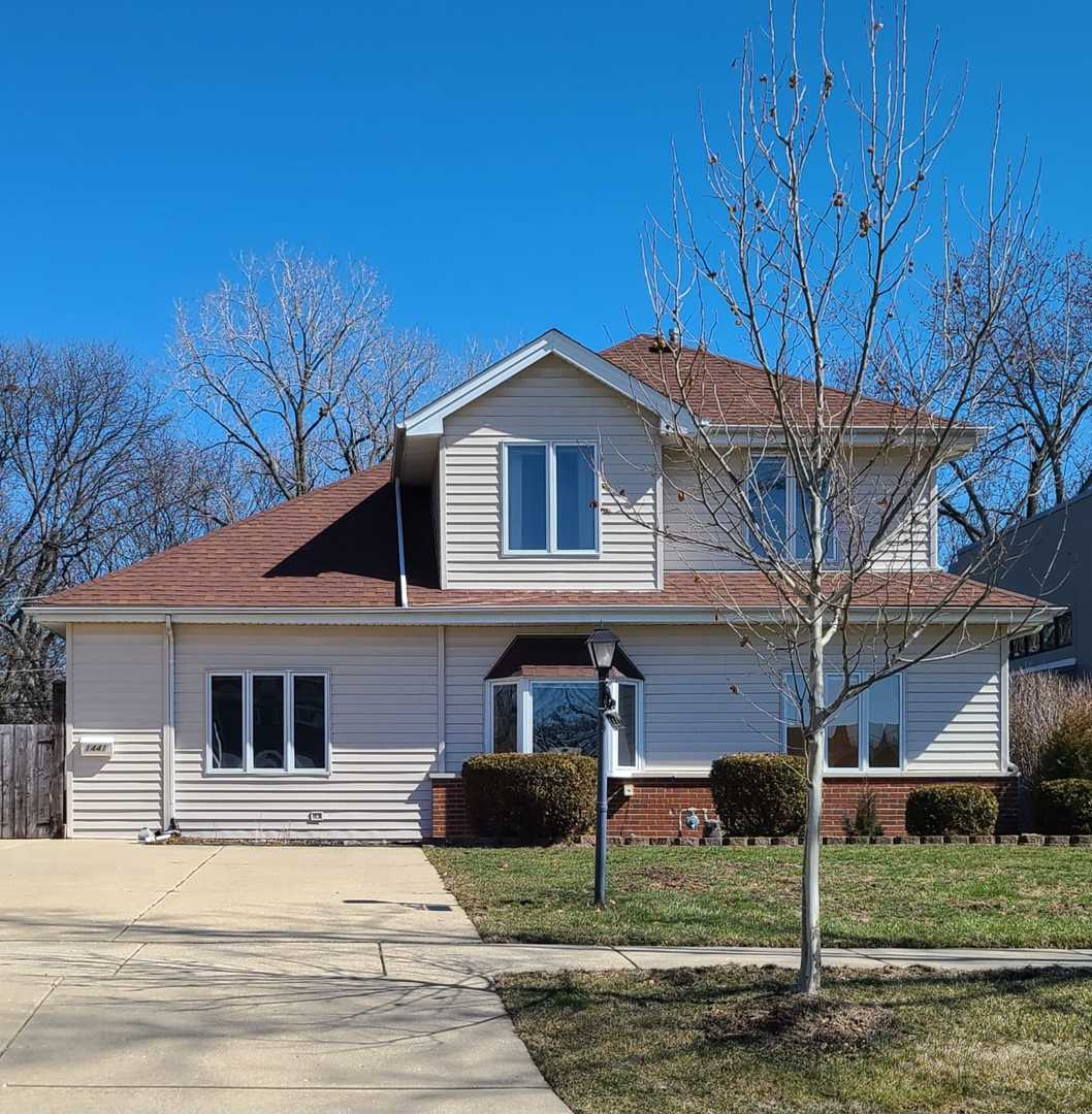 1441 Maple Street Glenview, IL 60025 - Photo 1 of 22 a front view of a house with garden