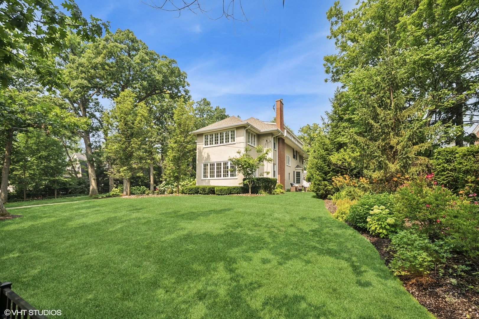 646 Prospect Avenue Winnetka, IL 60093 - Photo 13 of 22 a view of a house with a big yard and large trees