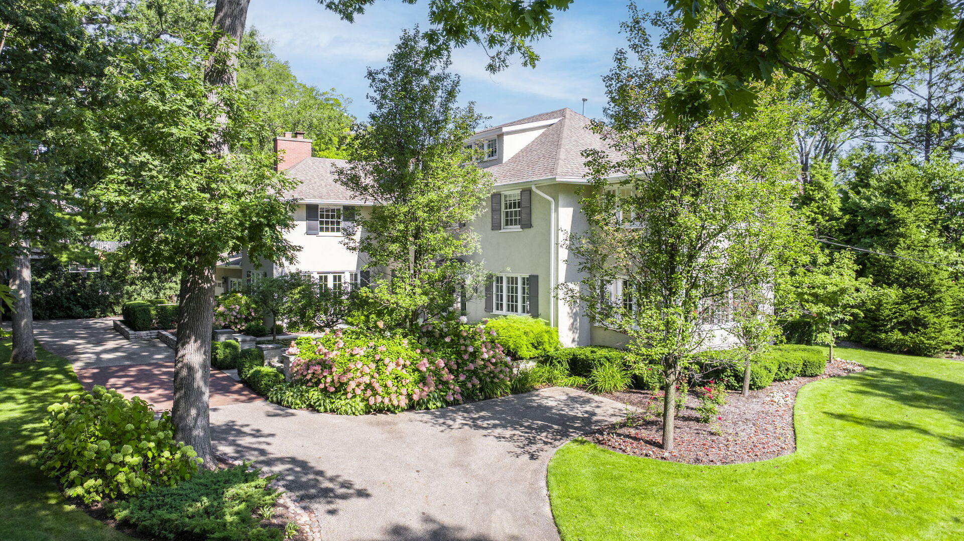 646 Prospect Avenue Winnetka, IL 60093 - Photo 17 of 22 a front view of a house with a yard and fountain