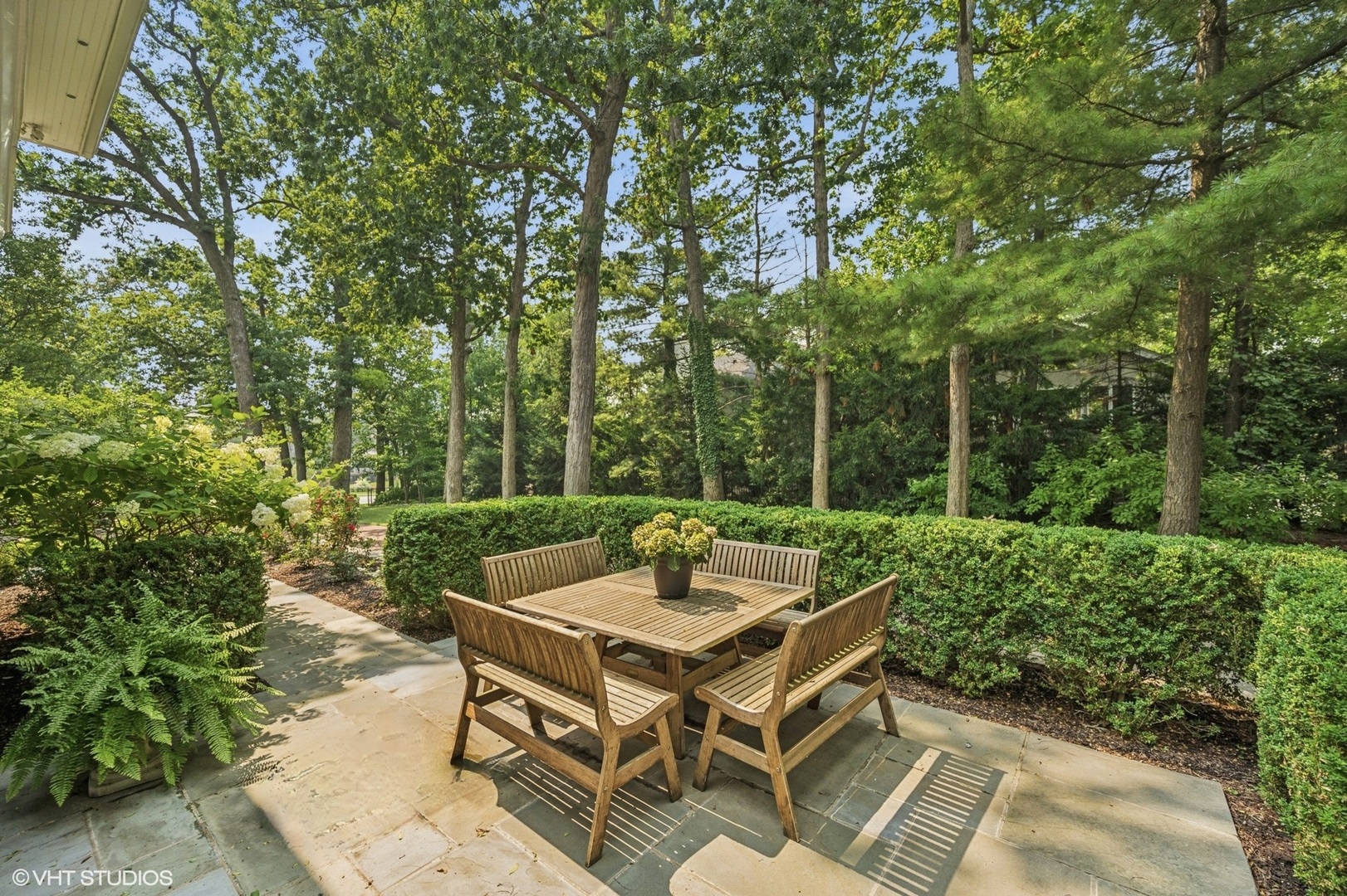 646 Prospect Avenue Winnetka, IL 60093 - Photo 8 of 22 a view of a patio with table and chairs and a large tree