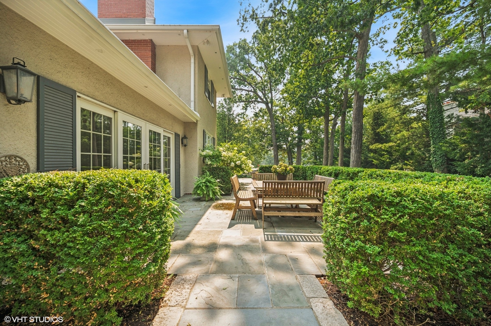 646 Prospect Avenue Winnetka, IL 60093 - Photo 9 of 22 a view of a house with backyard sitting area and garden