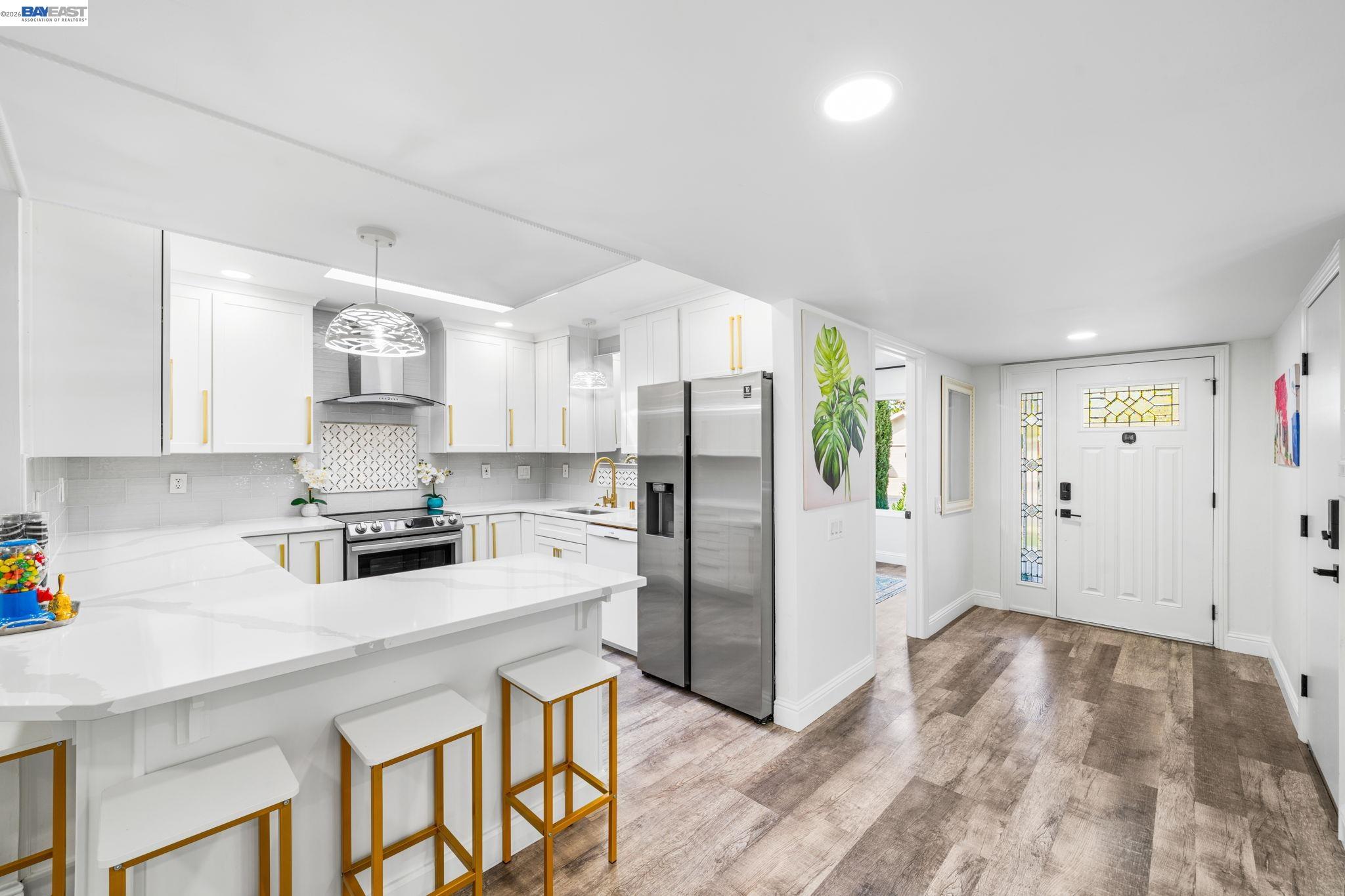 4019 Rennellwood Way Pleasanton, CA 94566 - Photo 13 of 48 a kitchen with stainless steel appliances a stove refrigerator sink and cabinets