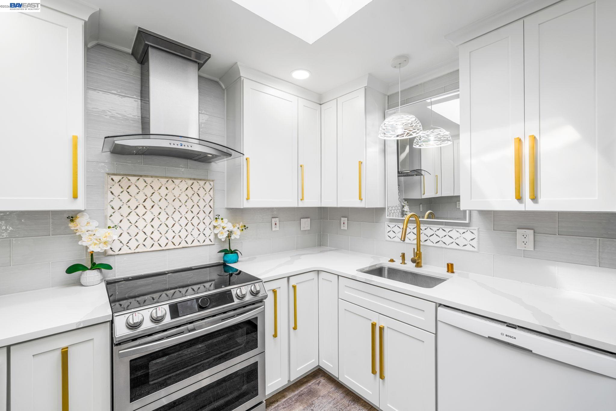 4019 Rennellwood Way Pleasanton, CA 94566 - Photo 15 of 48 a kitchen with a stove a sink and a microwave
