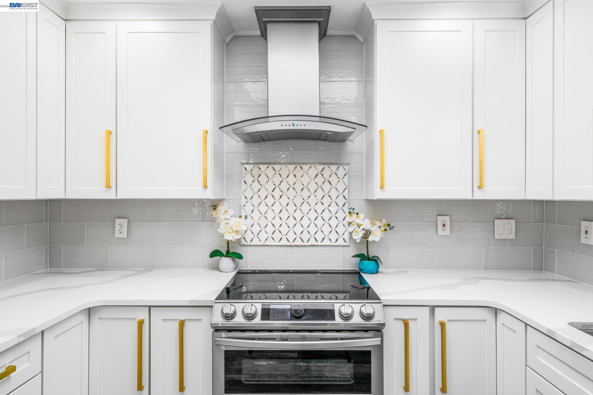 4019 Rennellwood Way Pleasanton, CA 94566 - Photo 16 of 48 a kitchen with a stove and white cabinets