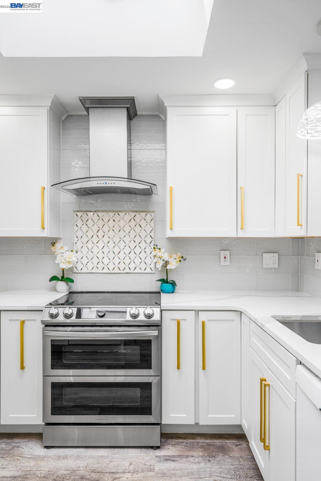 4019 Rennellwood Way Pleasanton, CA 94566 - Photo 17 of 48 a kitchen with white cabinets and appliances