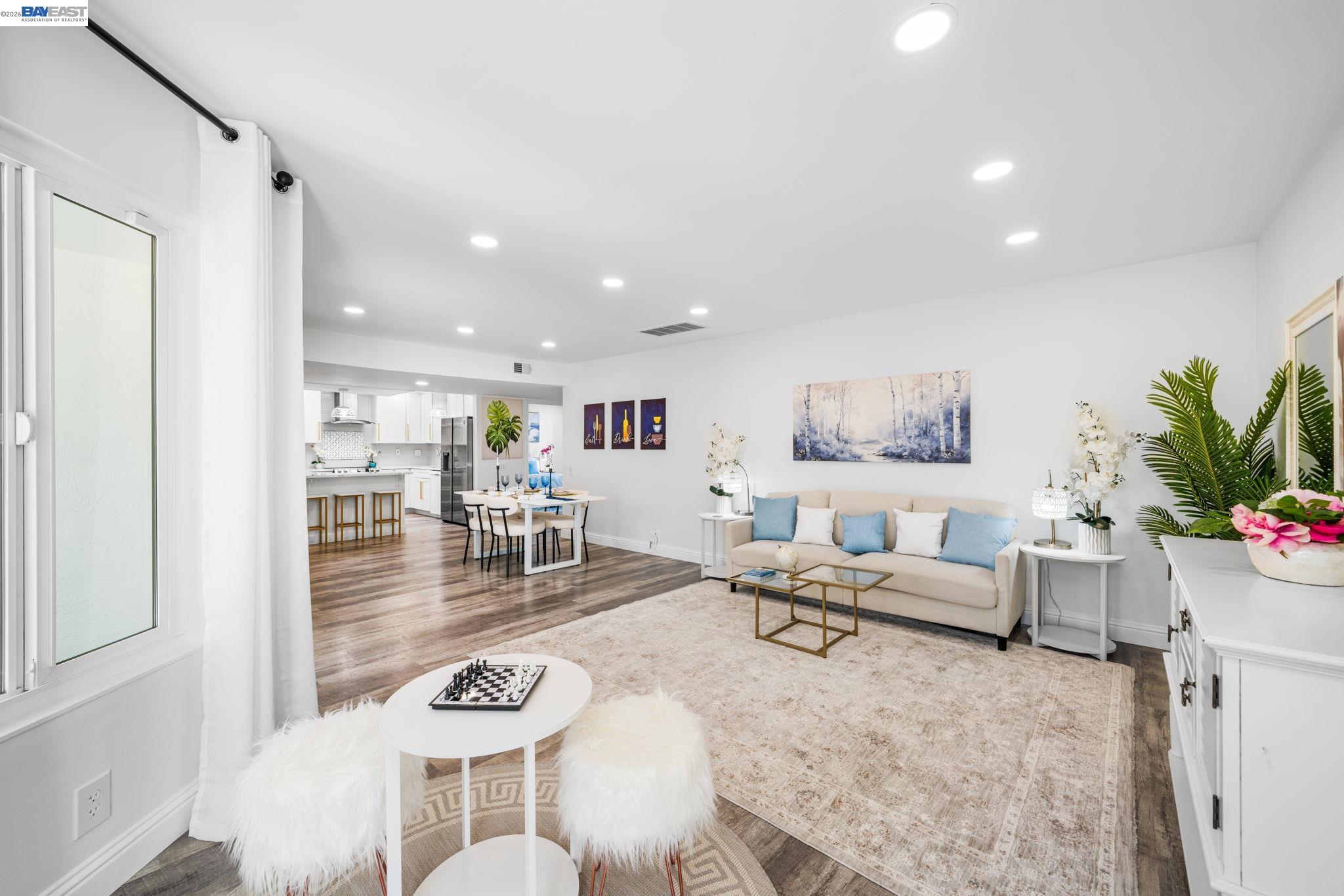 4019 Rennellwood Way Pleasanton, CA 94566 - Photo 24 of 48 a living room with furniture and a dining table with kitchen view