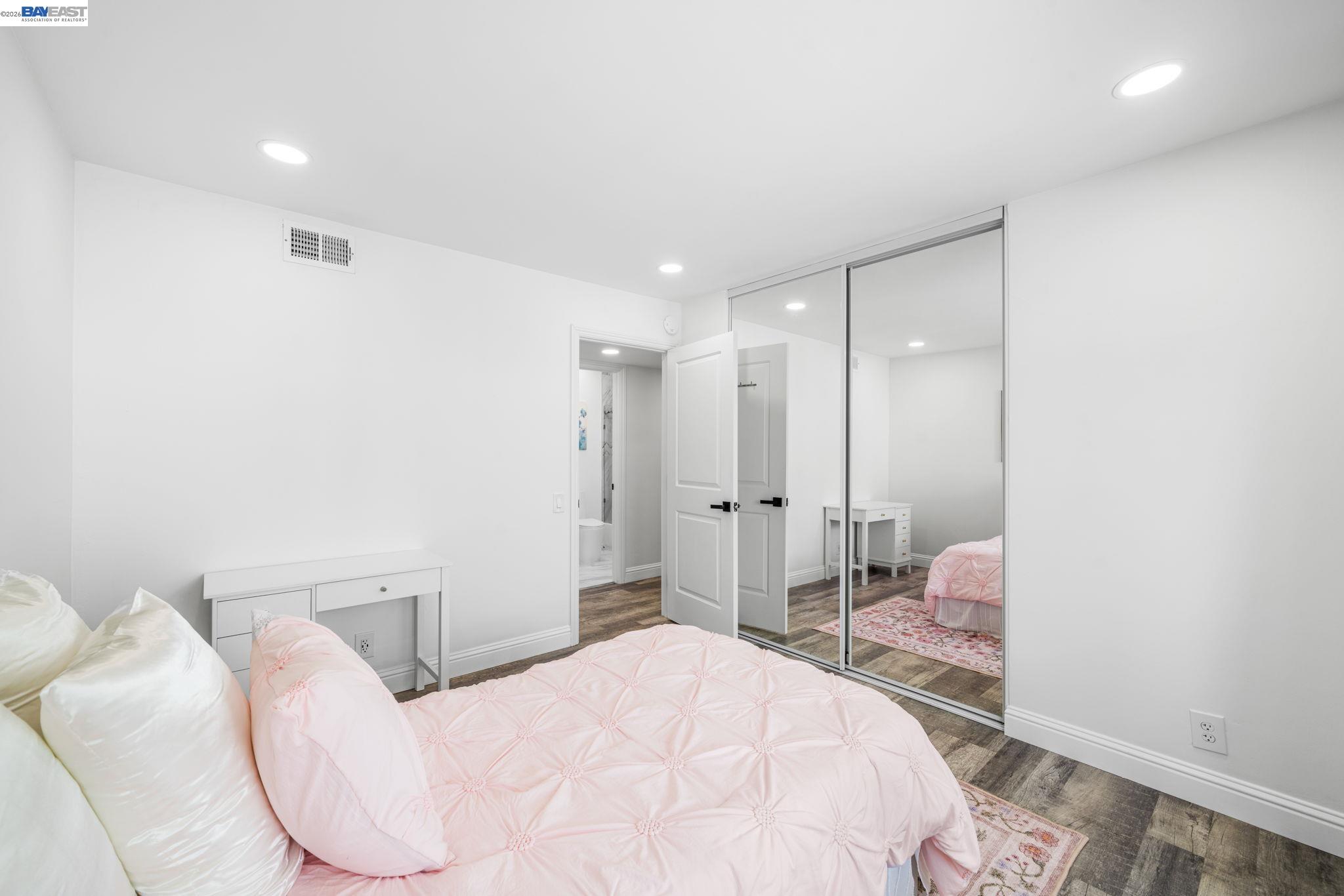 4019 Rennellwood Way Pleasanton, CA 94566 - Photo 33 of 48 a bedroom with a bed and a mirror