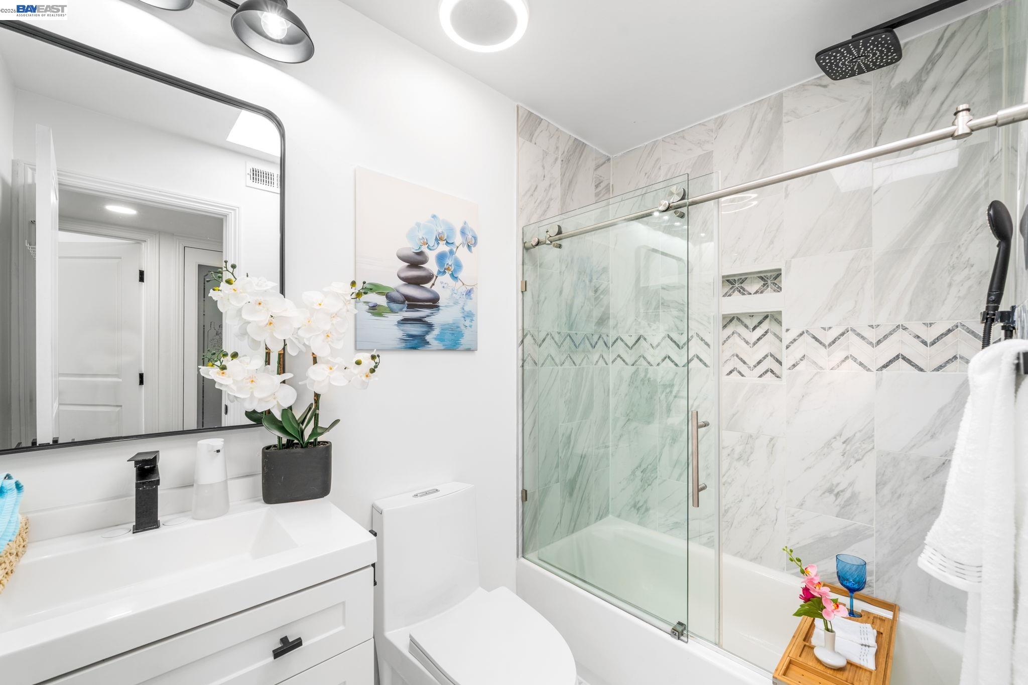 4019 Rennellwood Way Pleasanton, CA 94566 - Photo 35 of 48 a bathroom with a shower a sink and a mirror