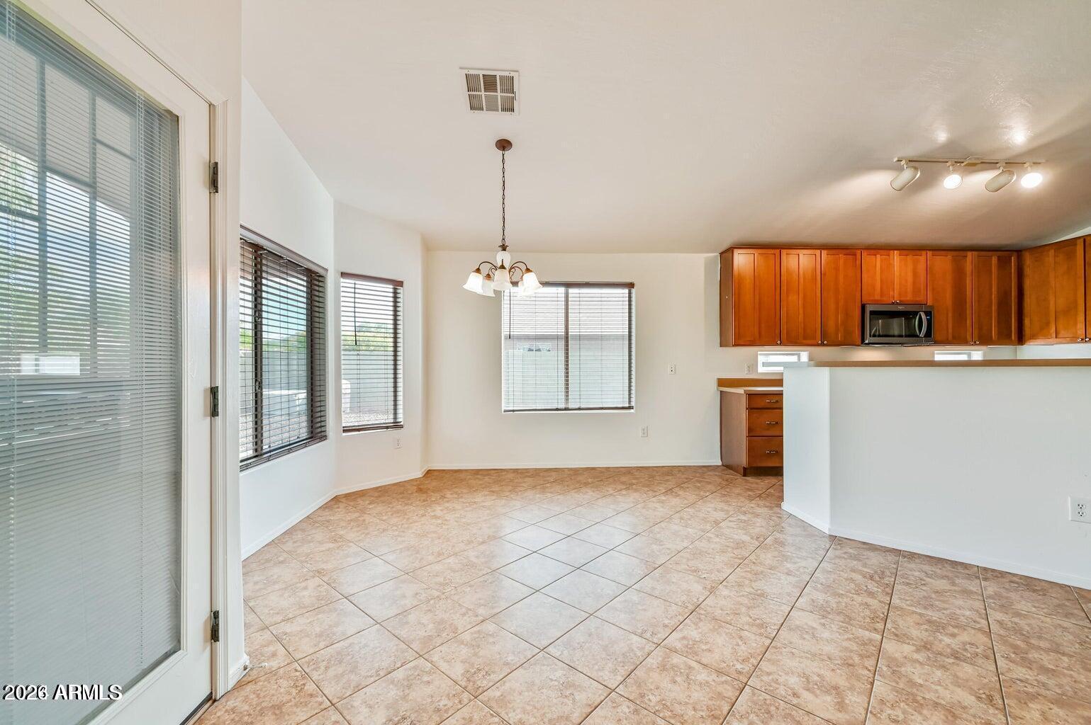 7809 South 20th Lane Phoenix, AZ 85041 - Photo 11 of 31 a view of a kitchen with a sink and windows