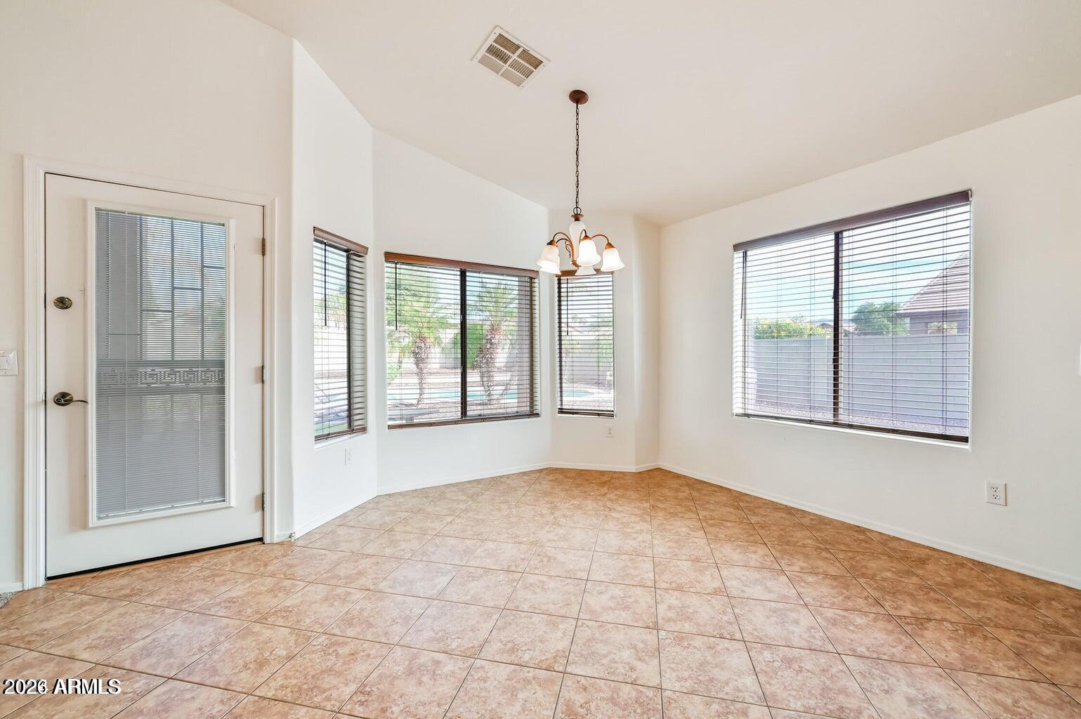 7809 South 20th Lane Phoenix, AZ 85041 - Photo 12 of 31 a view of an empty room with a window