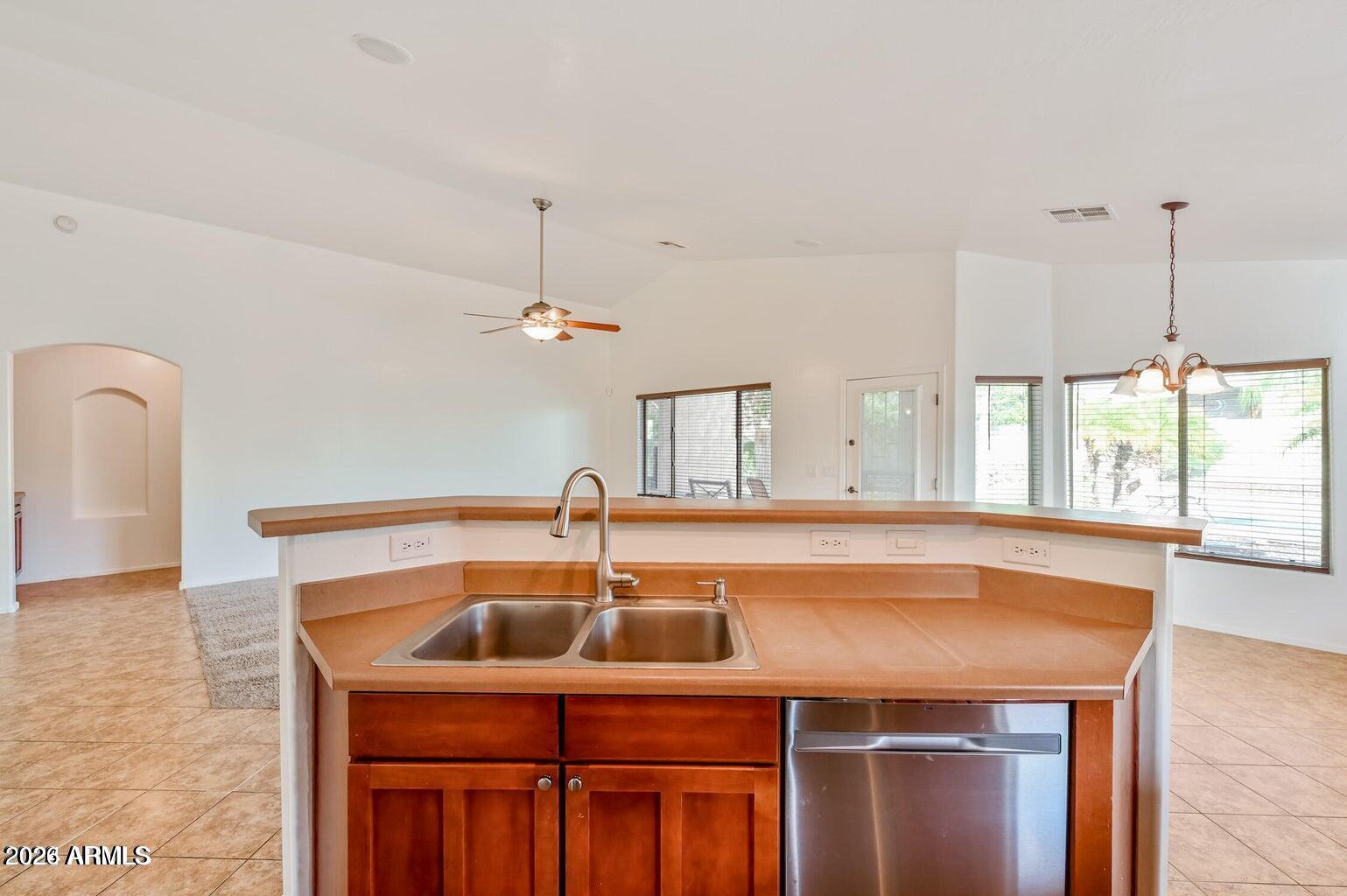 7809 South 20th Lane Phoenix, AZ 85041 - Photo 16 of 31 a kitchen with a sink a counter space and a window