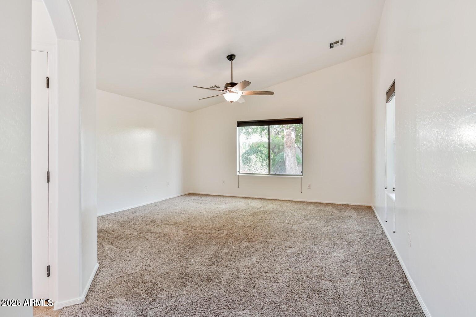 7809 South 20th Lane Phoenix, AZ 85041 - Photo 19 of 31 an empty room with windows and ceiling fan