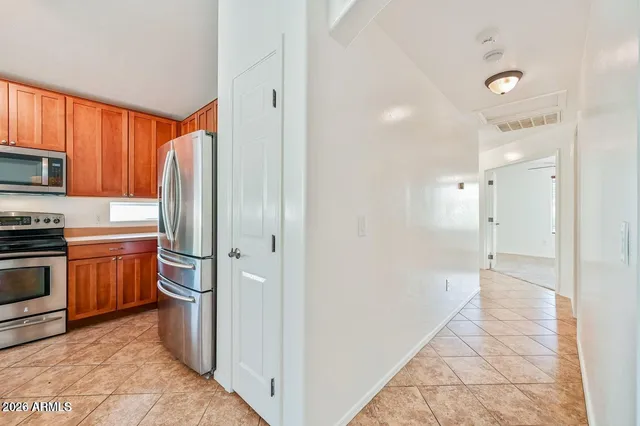 a view of a kitchen with a sink and refrigerator