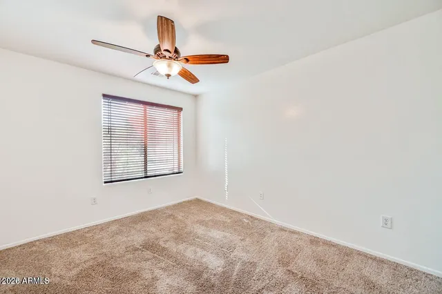 a view of a chandelier fan and a window