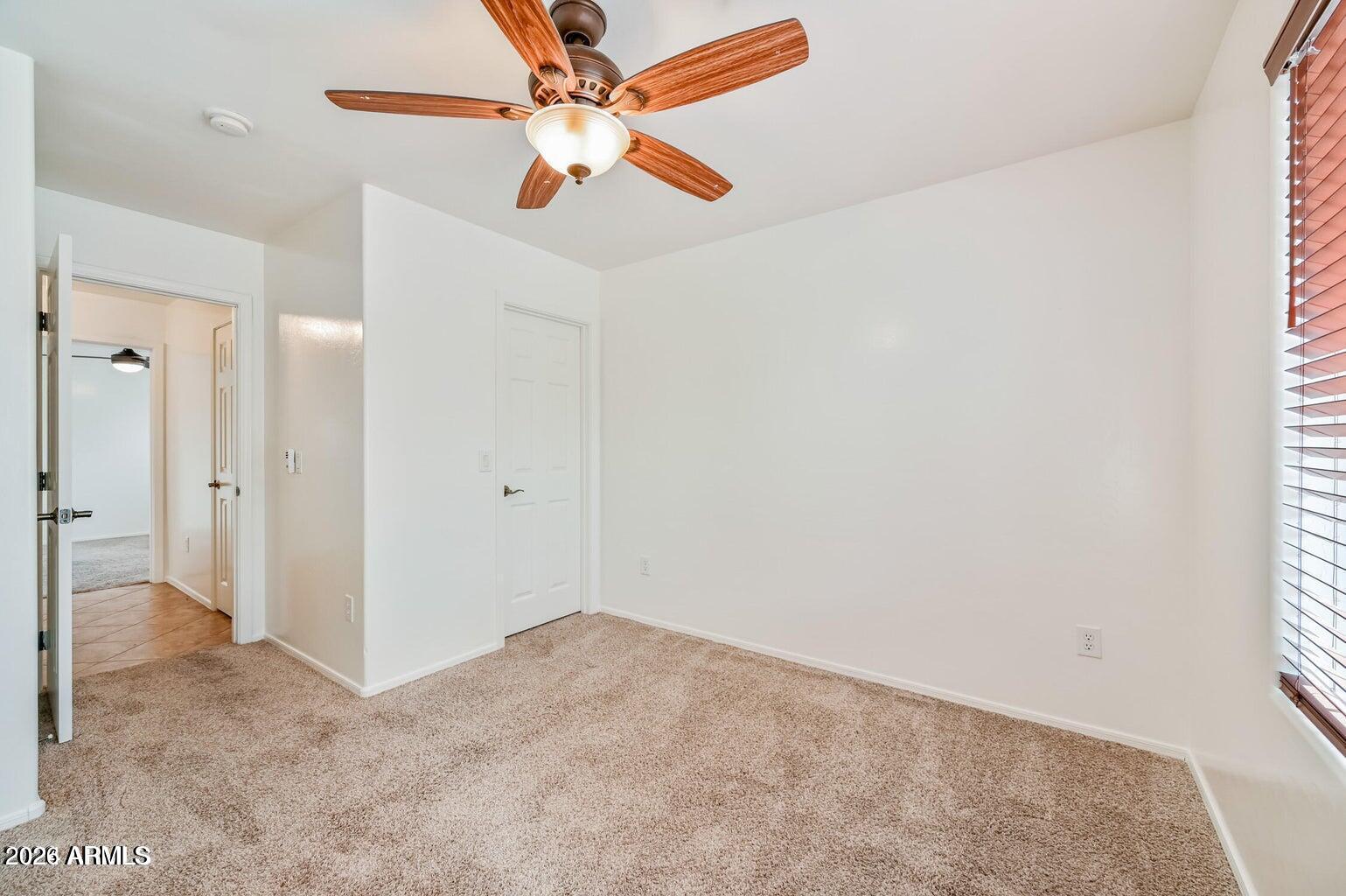 7809 South 20th Lane Phoenix, AZ 85041 - Photo 27 of 31 a view of a big room with closet and a chandelier fan