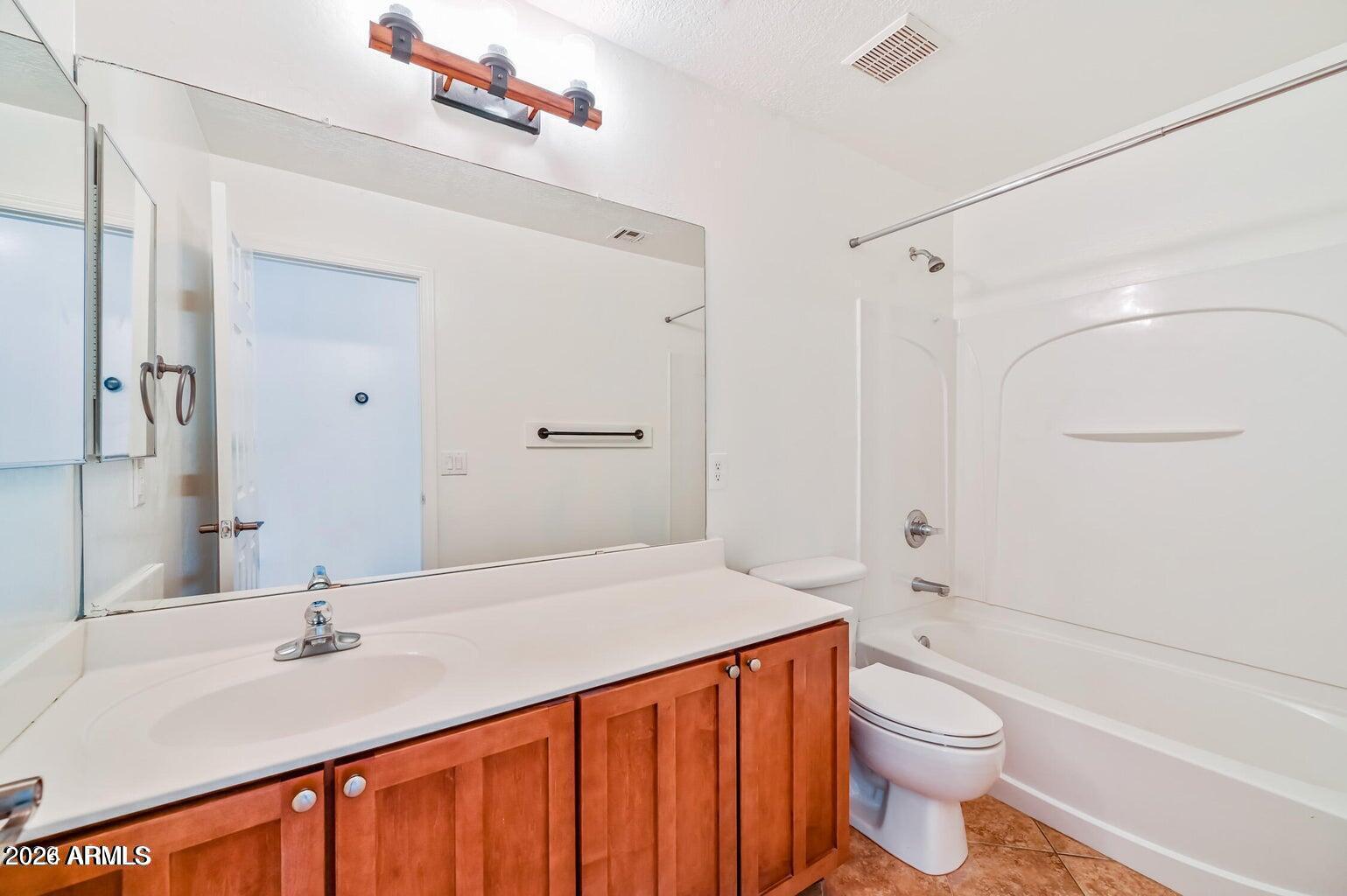 7809 South 20th Lane Phoenix, AZ 85041 - Photo 29 of 31 a bathroom with a sink a toilet and a bathtub