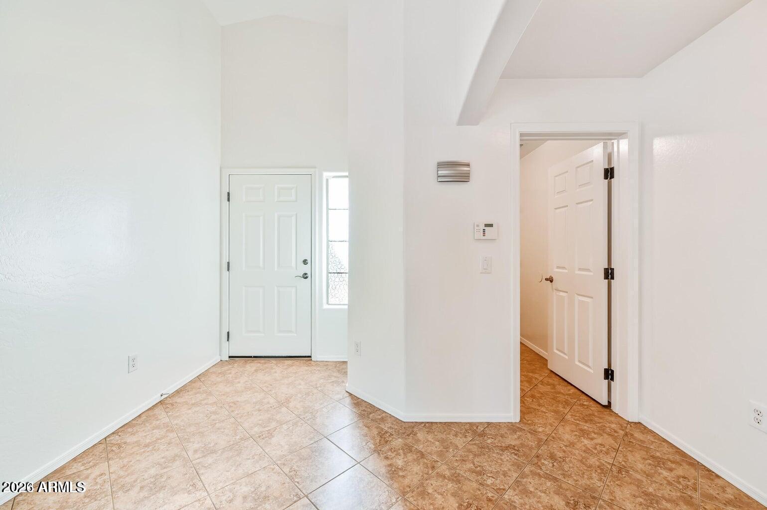 7809 South 20th Lane Phoenix, AZ 85041 - Photo 30 of 31 an empty room with wooden floor and mirror